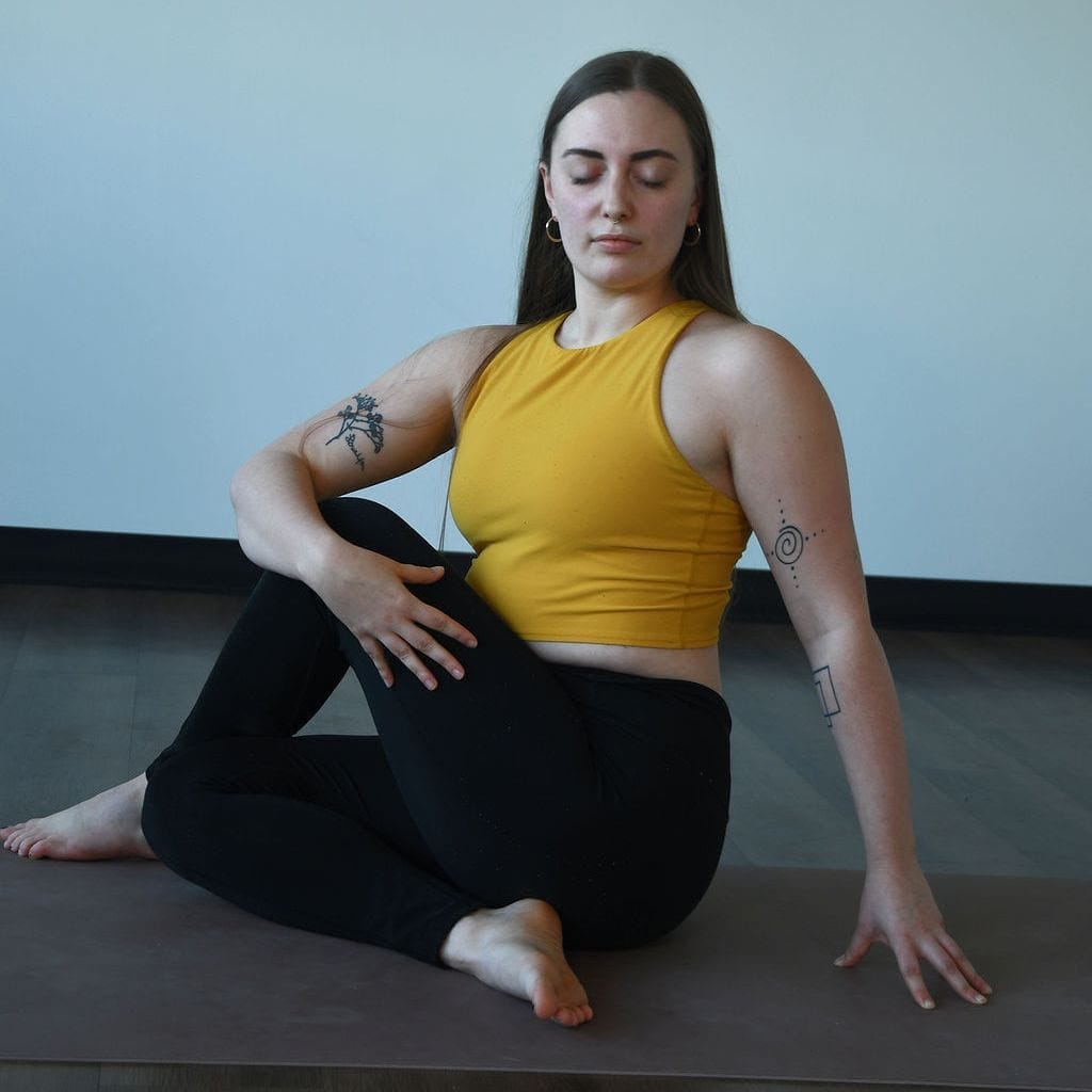 Zoe Lowden practices vairagya in ardha matsyendrasana