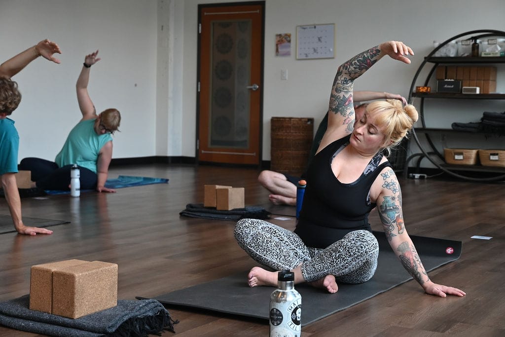 Lauren Patton in a seated side stretch